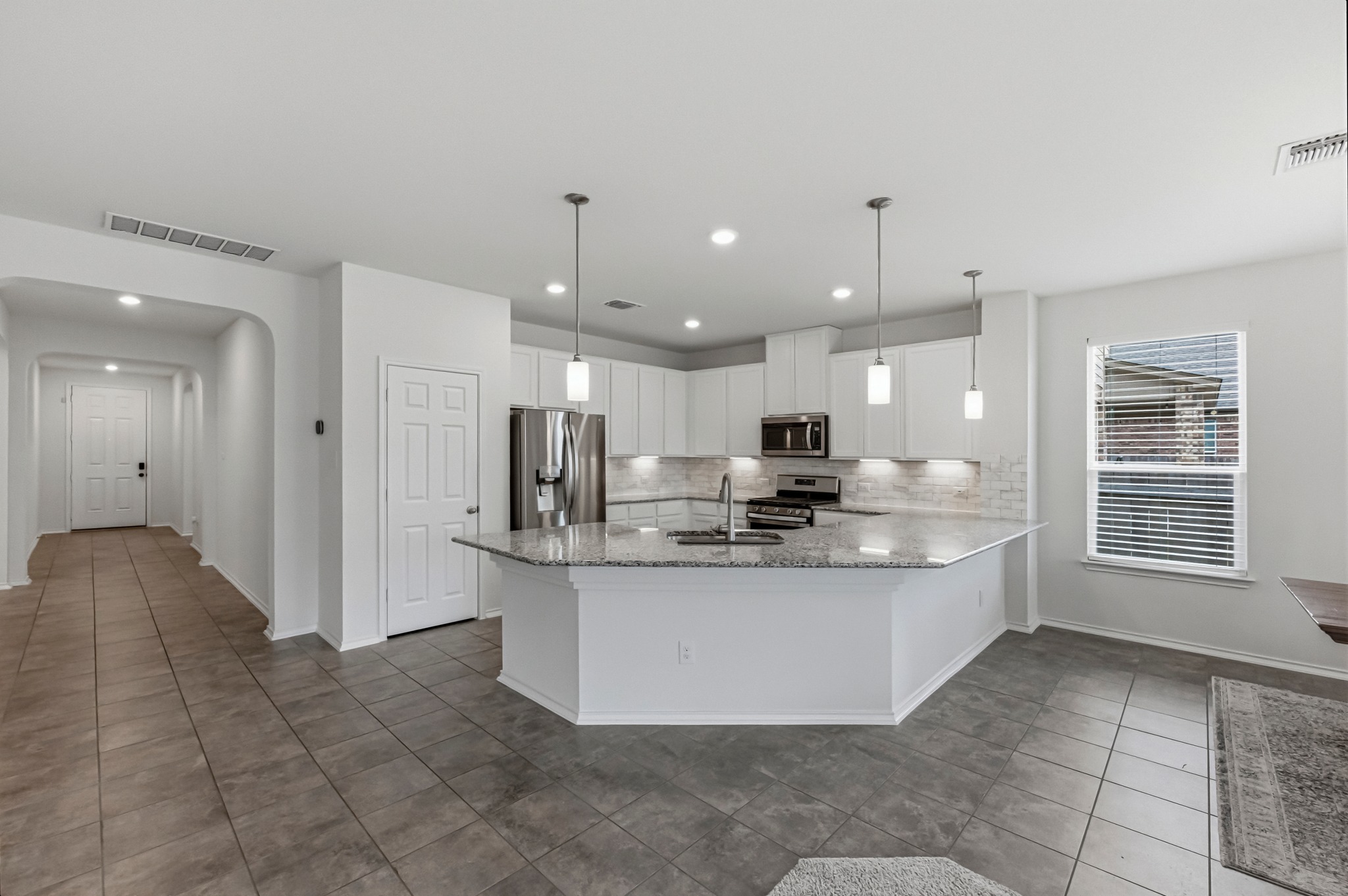 1236 Cornith Lane Leander, TX 78641 - Photo 8 of 32 a view of kitchen with stainless steel appliances granite countertop a sink and a refrigerator