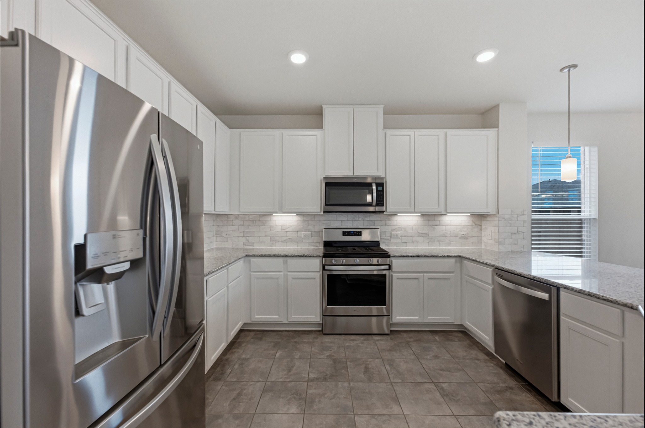 1236 Cornith Lane Leander, TX 78641 - Photo 10 of 32 a kitchen with stainless steel appliances granite countertop a refrigerator sink and microwave