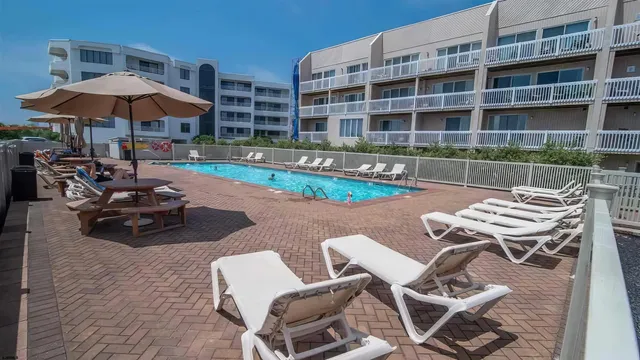 a view of a patio with a table and chairs under an umbrella