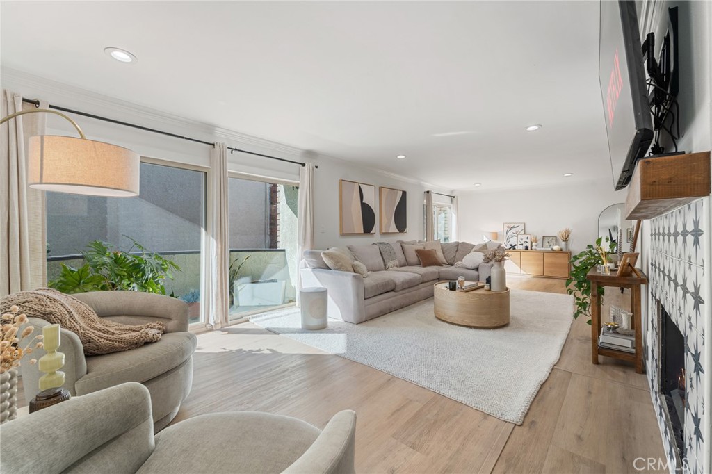 5440 Lindley Avenue, Unit 201 Encino, CA 91316 - Photo 1 of 38 a living room with furniture a fireplace and a potted plant