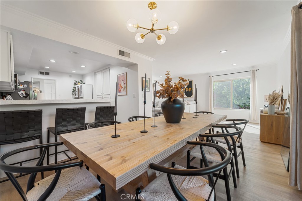 5440 Lindley Avenue, Unit 201 Encino, CA 91316 - Photo 12 of 38 a view of a dining room with furniture and a chandelier