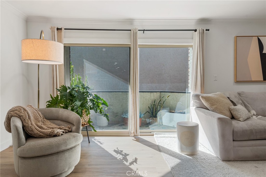 5440 Lindley Avenue, Unit 201 Encino, CA 91316 - Photo 2 of 38 a living room with furniture and a potted plant