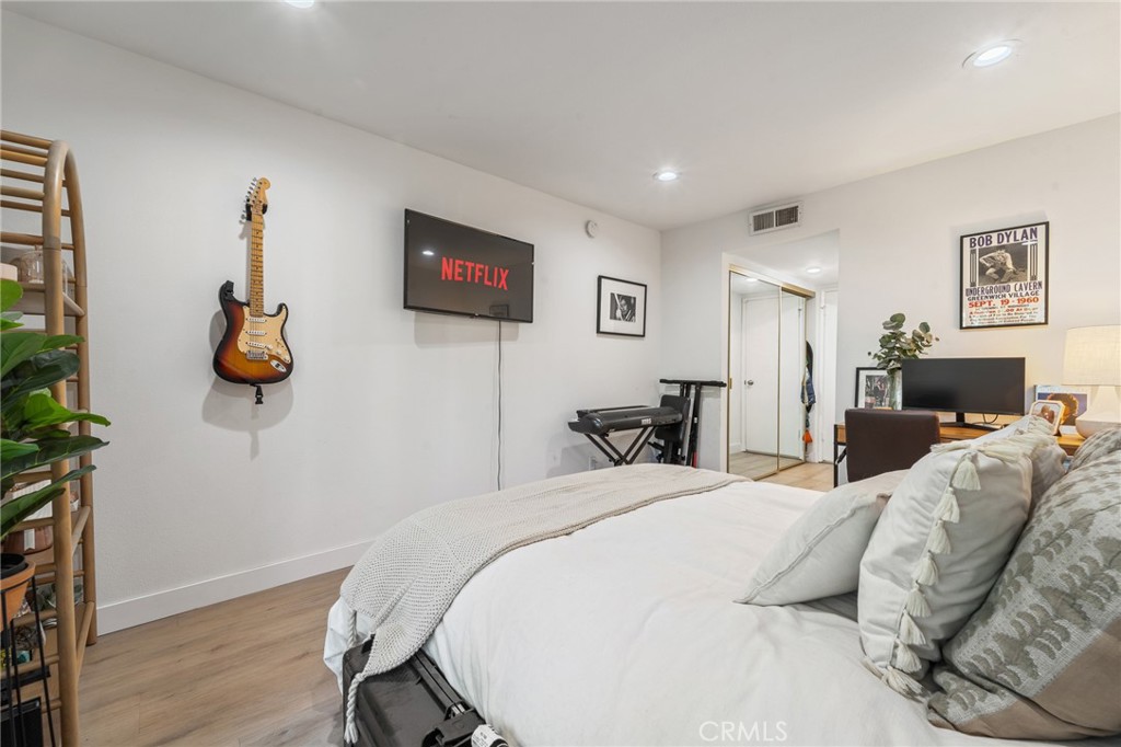 5440 Lindley Avenue, Unit 201 Encino, CA 91316 - Photo 21 of 38 a bedroom with a bed and a flat screen tv