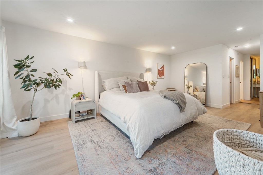 5440 Lindley Avenue, Unit 201 Encino, CA 91316 - Photo 25 of 38 a bedroom with a bed and a potted plant