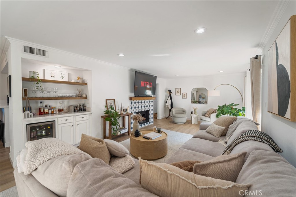 5440 Lindley Avenue, Unit 201 Encino, CA 91316 - Photo 6 of 38 a living room with furniture fireplace and a large window