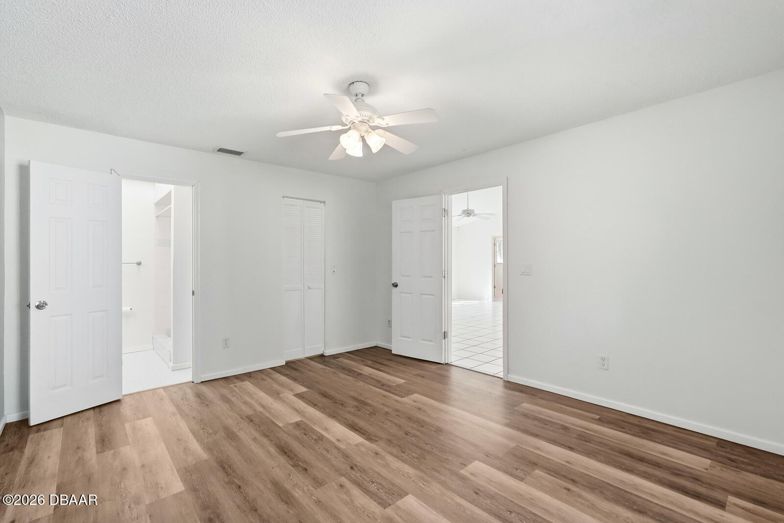 550 Locust Street Port Orange, FL 32127 - Photo 16 of 37 an empty room with wooden floor and ceiling fan