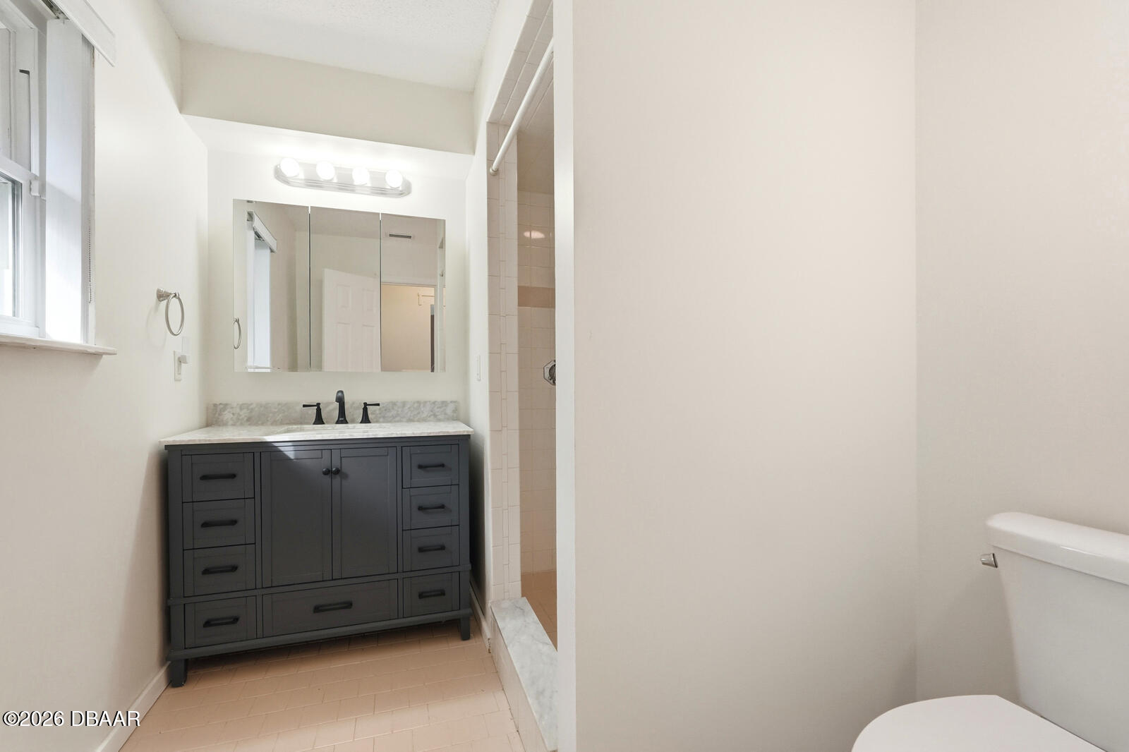 550 Locust Street Port Orange, FL 32127 - Photo 21 of 37 a bathroom with a sink vanity mirror and toilet