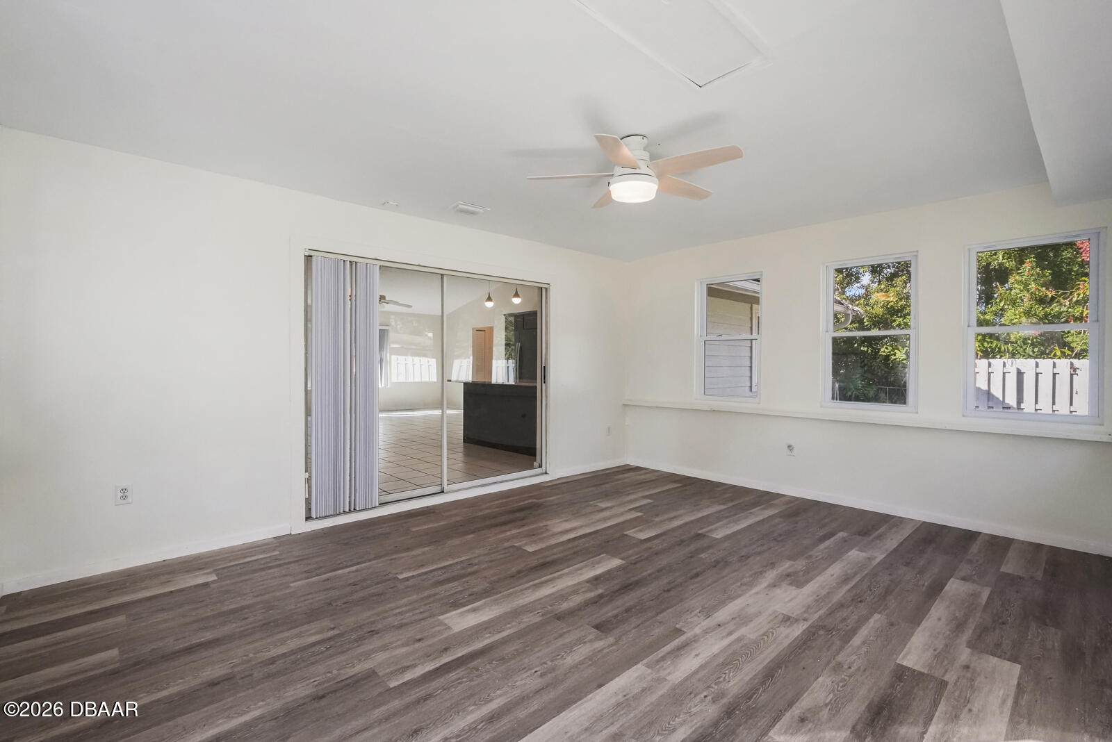 550 Locust Street Port Orange, FL 32127 - Photo 25 of 37 a view of an empty room with wooden floor and a window