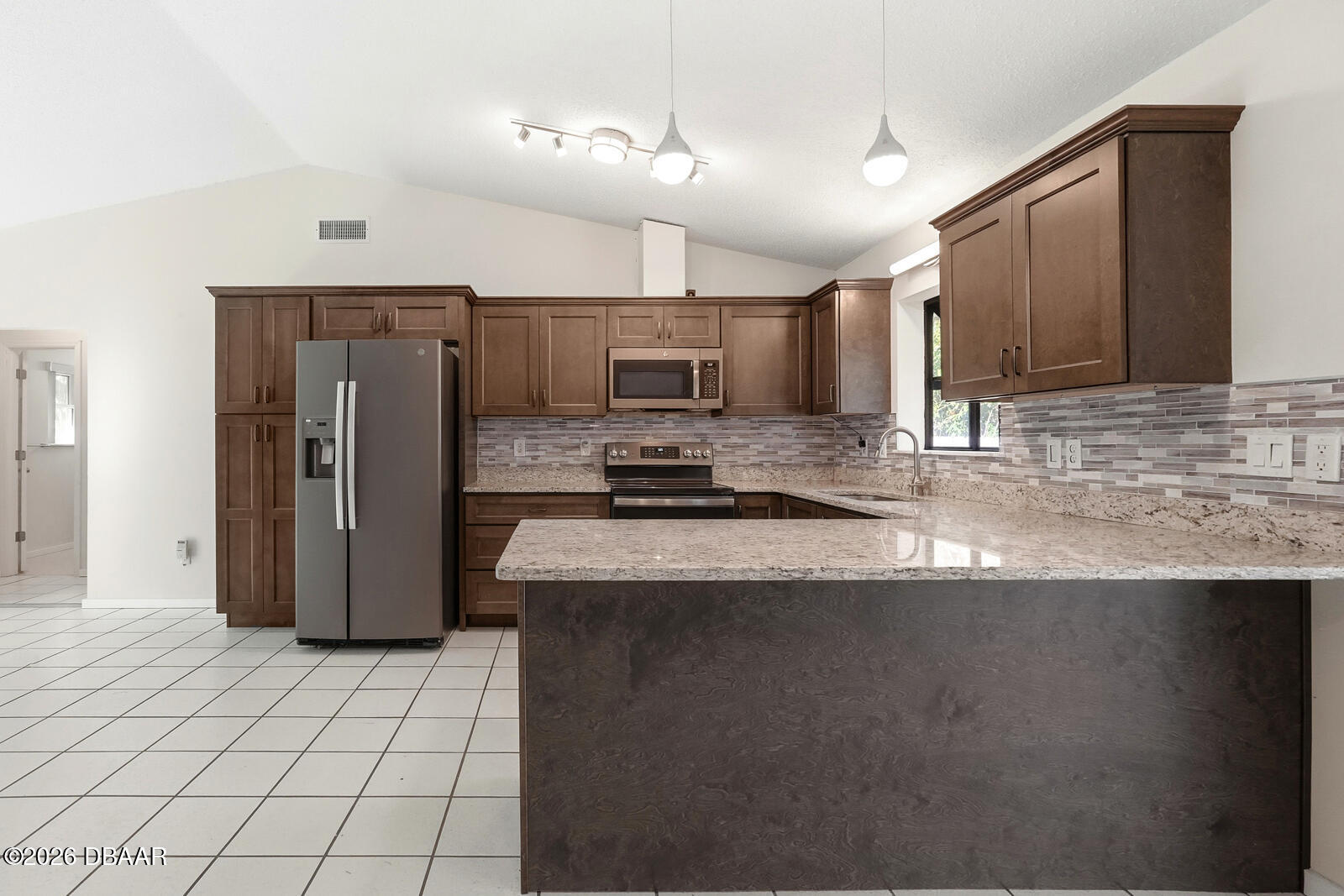 550 Locust Street Port Orange, FL 32127 - Photo 9 of 37 a kitchen with stainless steel appliances granite countertop a refrigerator a stove a sink and a oven