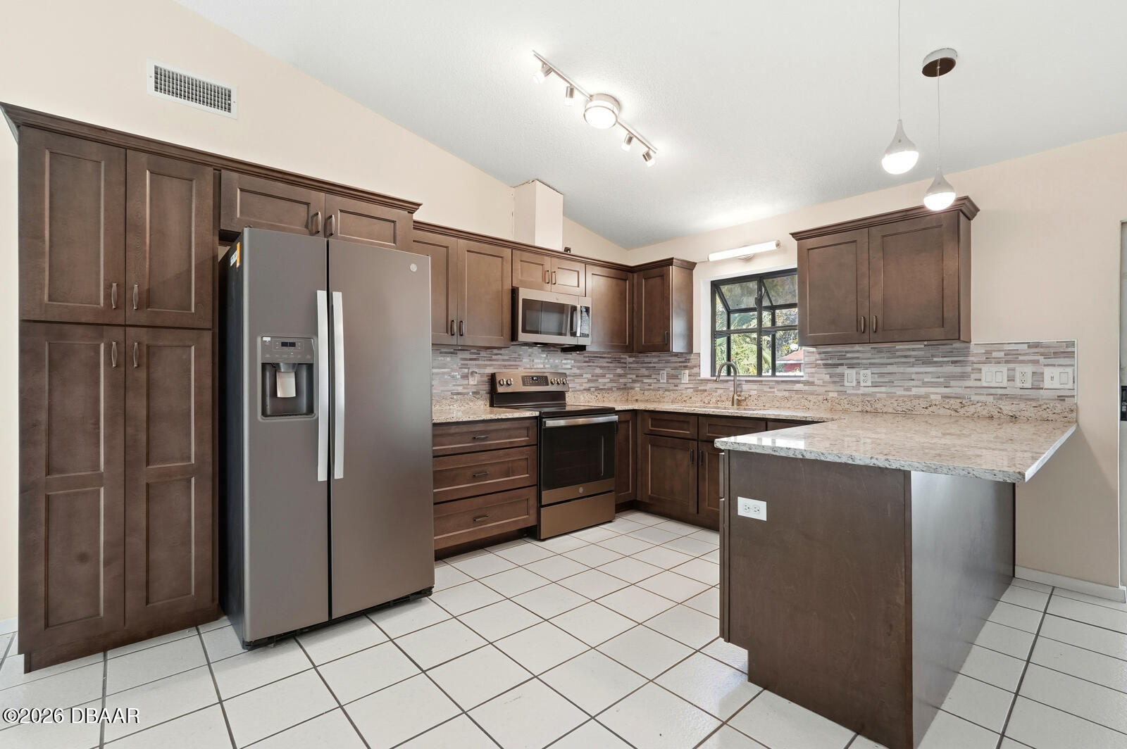 550 Locust Street Port Orange, FL 32127 - Photo 10 of 37 a kitchen with stainless steel appliances granite countertop a refrigerator and a stove