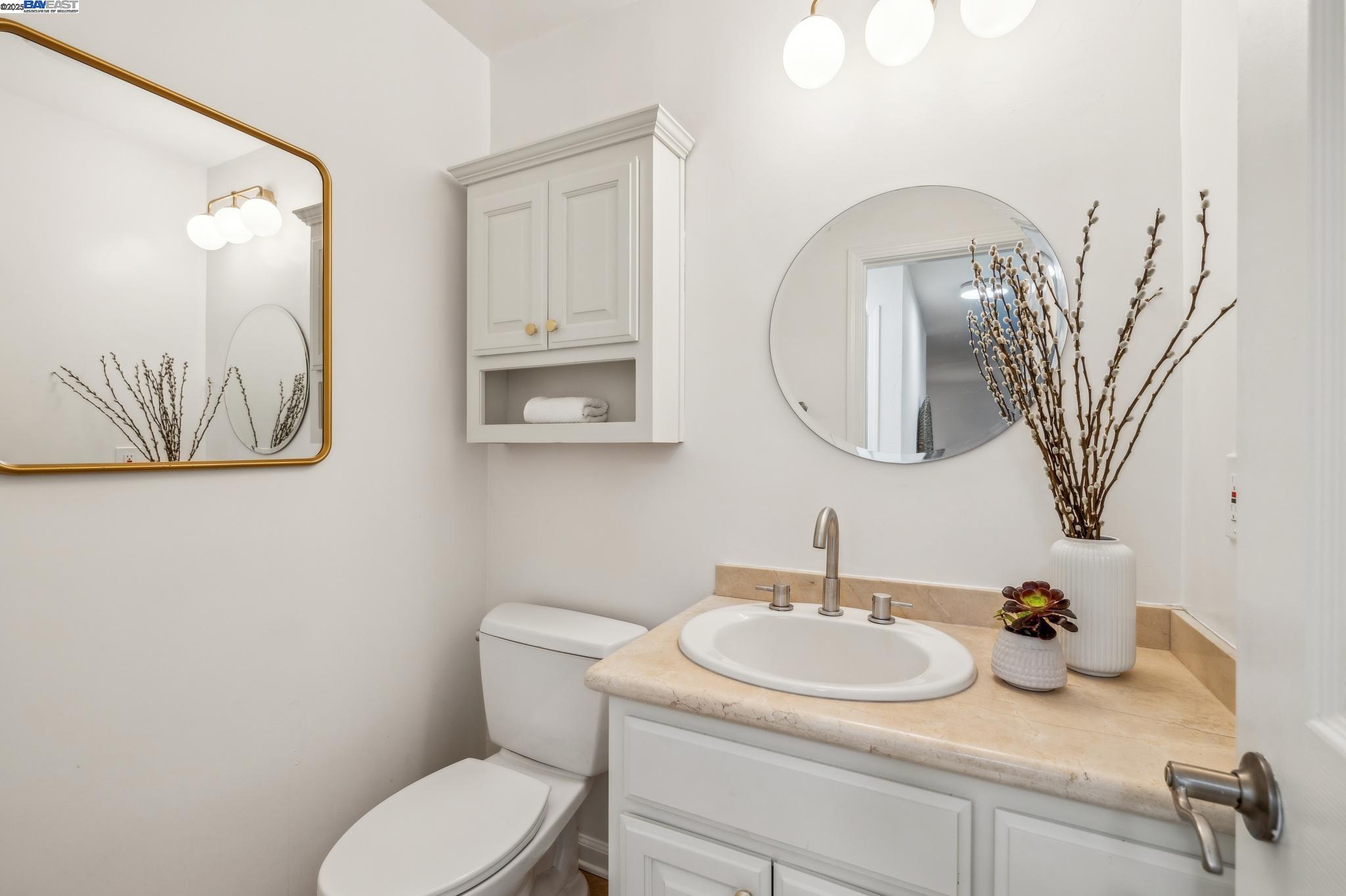 700 Fargo Avenue, Unit 2 San Leandro, CA 94579 - Photo 13 of 39 a bathroom with a toilet sink and mirror
