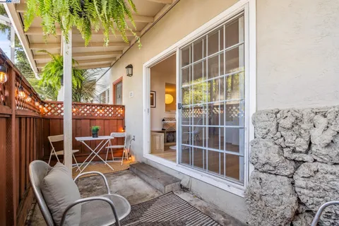 a view of a chairs and table in the balcony