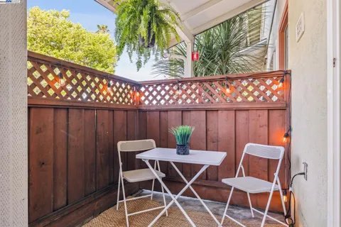 a view of a dining room with furniture wooden floor and a potted plant