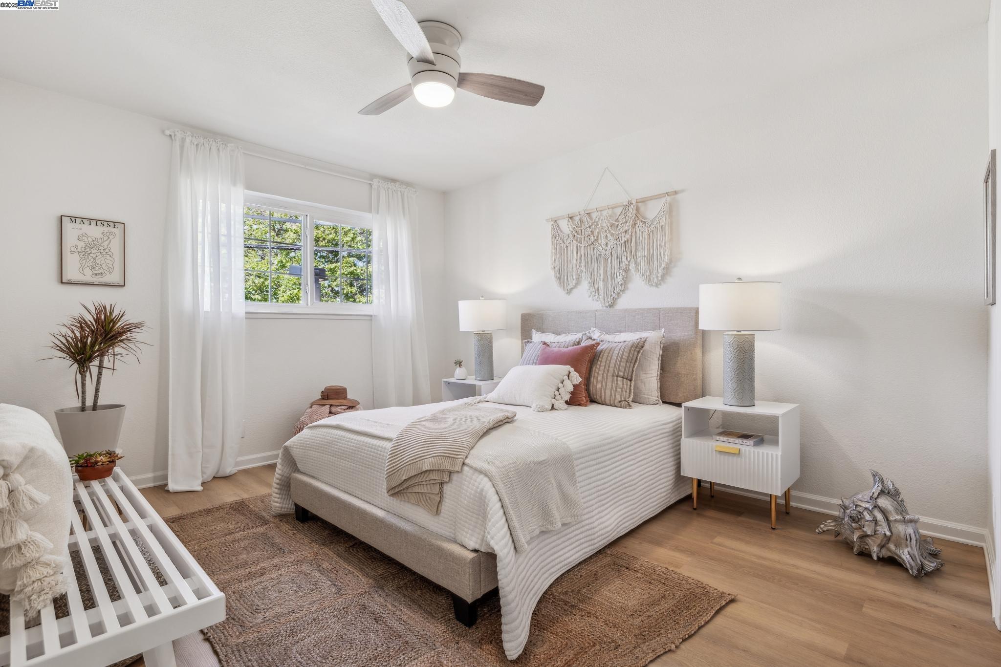 700 Fargo Avenue, Unit 2 San Leandro, CA 94579 - Photo 19 of 39 a bedroom with a bed and a chandelier