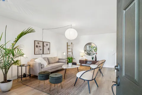 a living room with furniture a table and chair