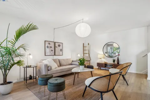 a living room with furniture a table and chair