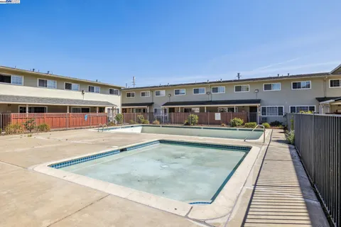 a view of a patio with chair and tables