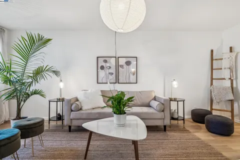 a living room with furniture potted plant and a chandelier