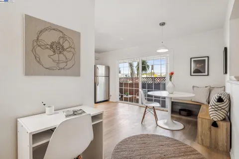 a living room with furniture a rug and white walls