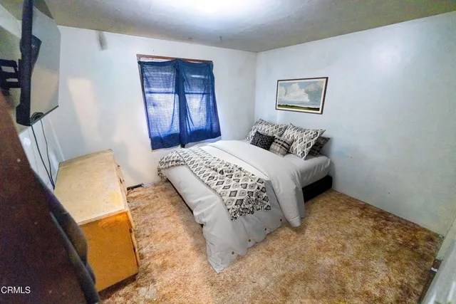 a bedroom with a bed and a mirror