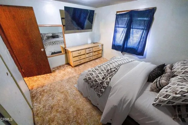 a bedroom with a bed and a dresser