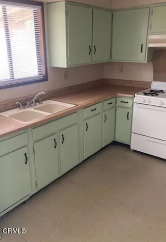 a utility room with cabinets washer and dryer