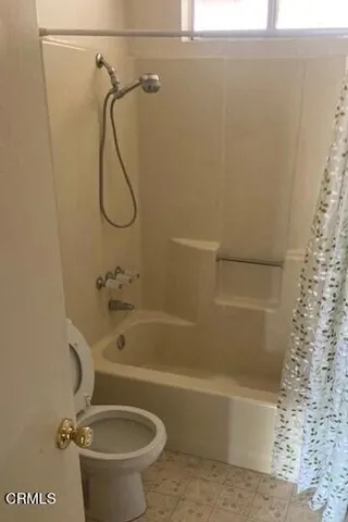 a bathroom with a shower and a toilet
