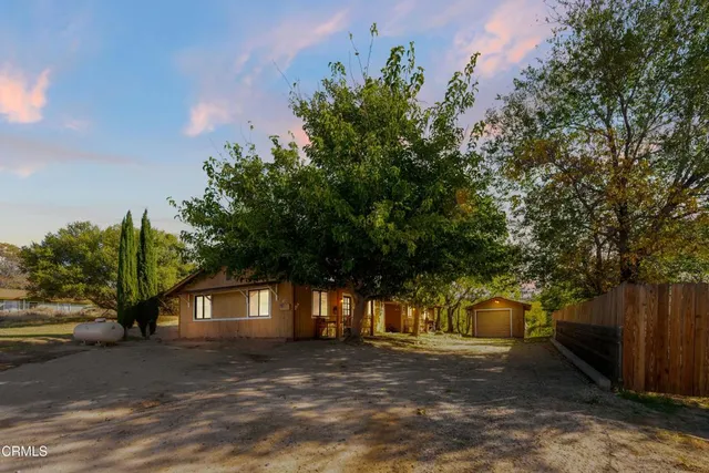 a view of a house with a tree