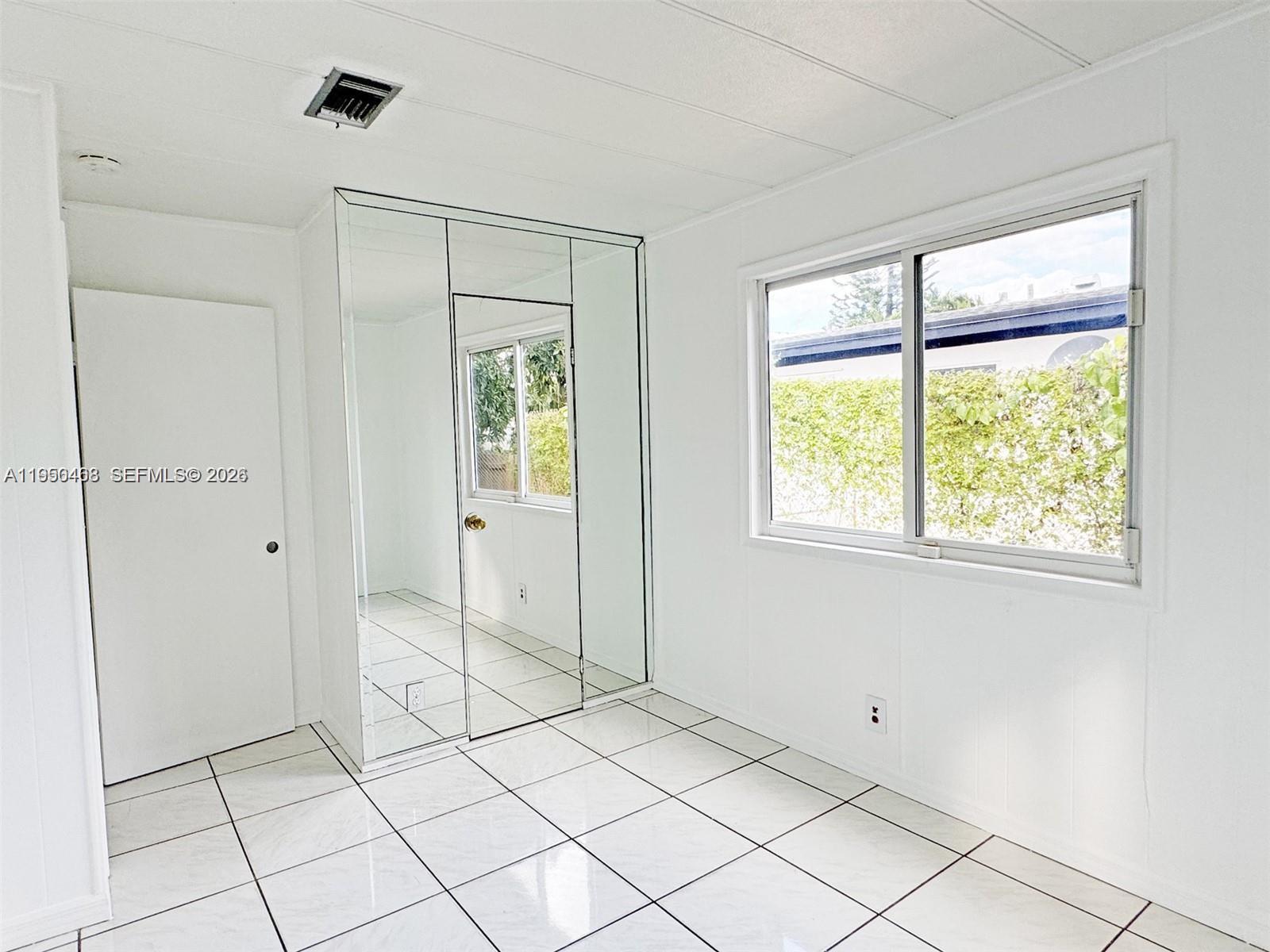 2982 Northwest 95th Street Miami, FL 33147 - Photo 17 of 30 a view of an empty room and window