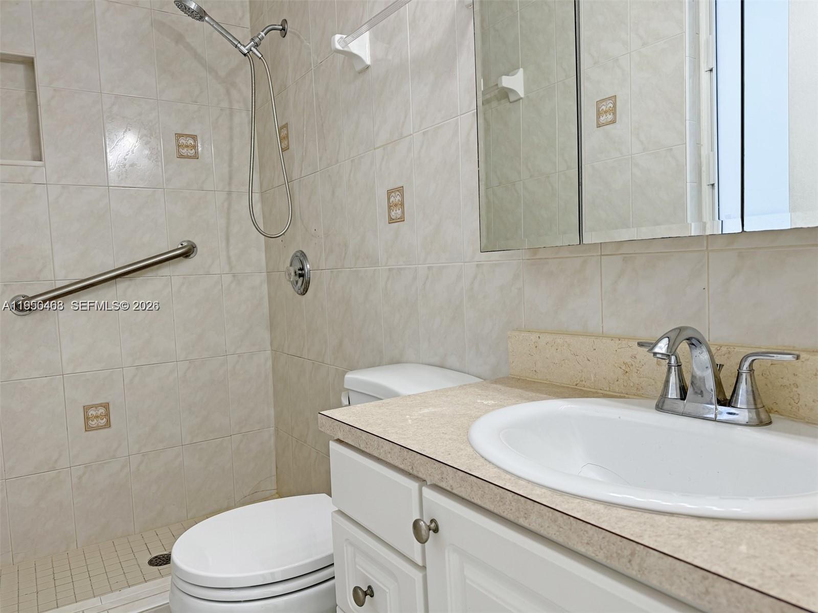 2982 Northwest 95th Street Miami, FL 33147 - Photo 23 of 30 a bathroom with a sink a toilet and shower