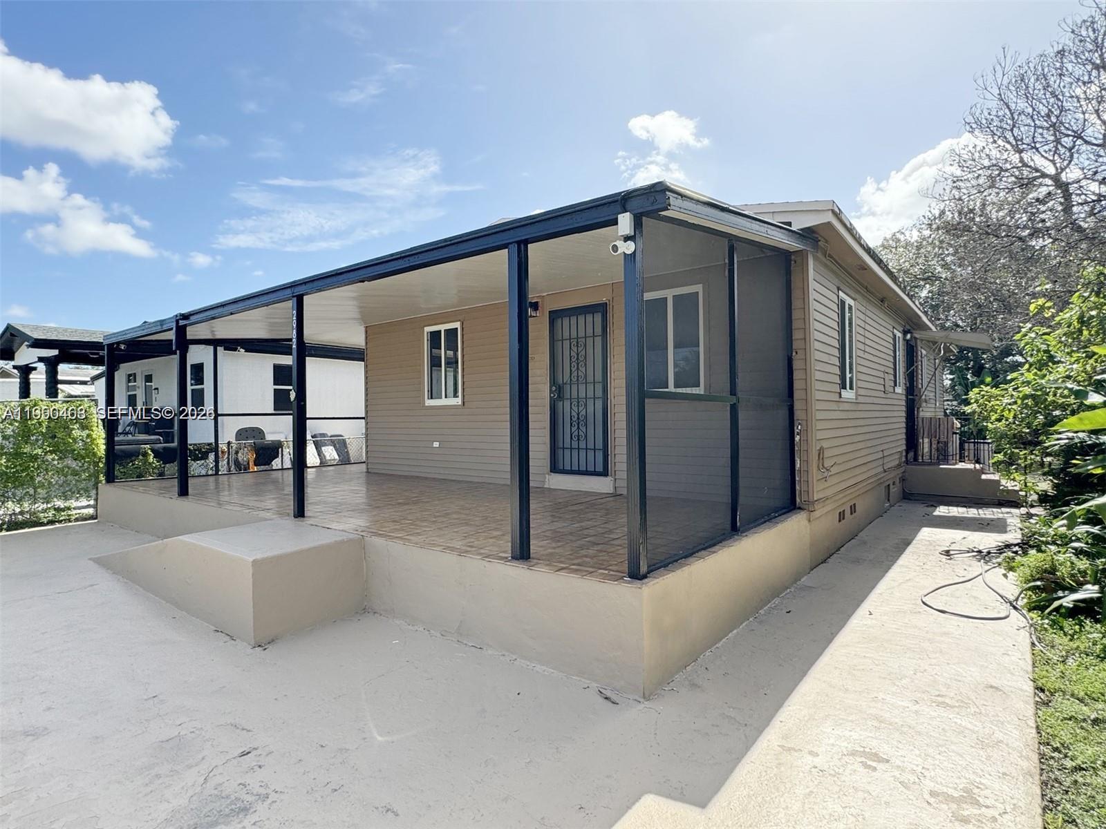 2982 Northwest 95th Street Miami, FL 33147 - Photo 27 of 30 a front view of a house with patio