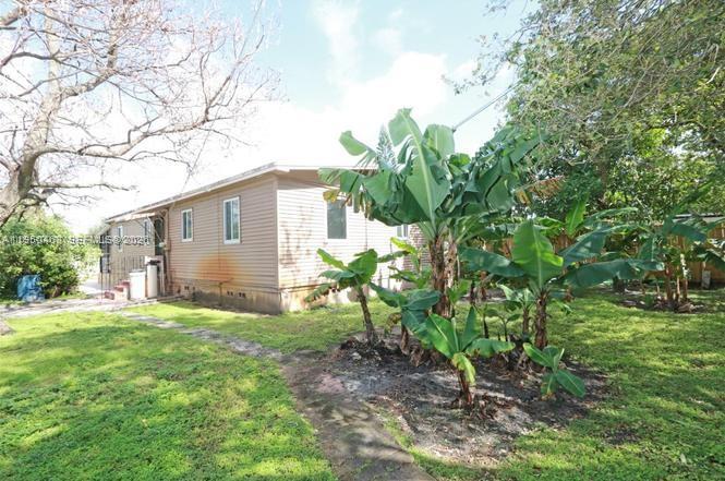 2982 Northwest 95th Street Miami, FL 33147 - Photo 29 of 30 a backyard of a house with table and chairs