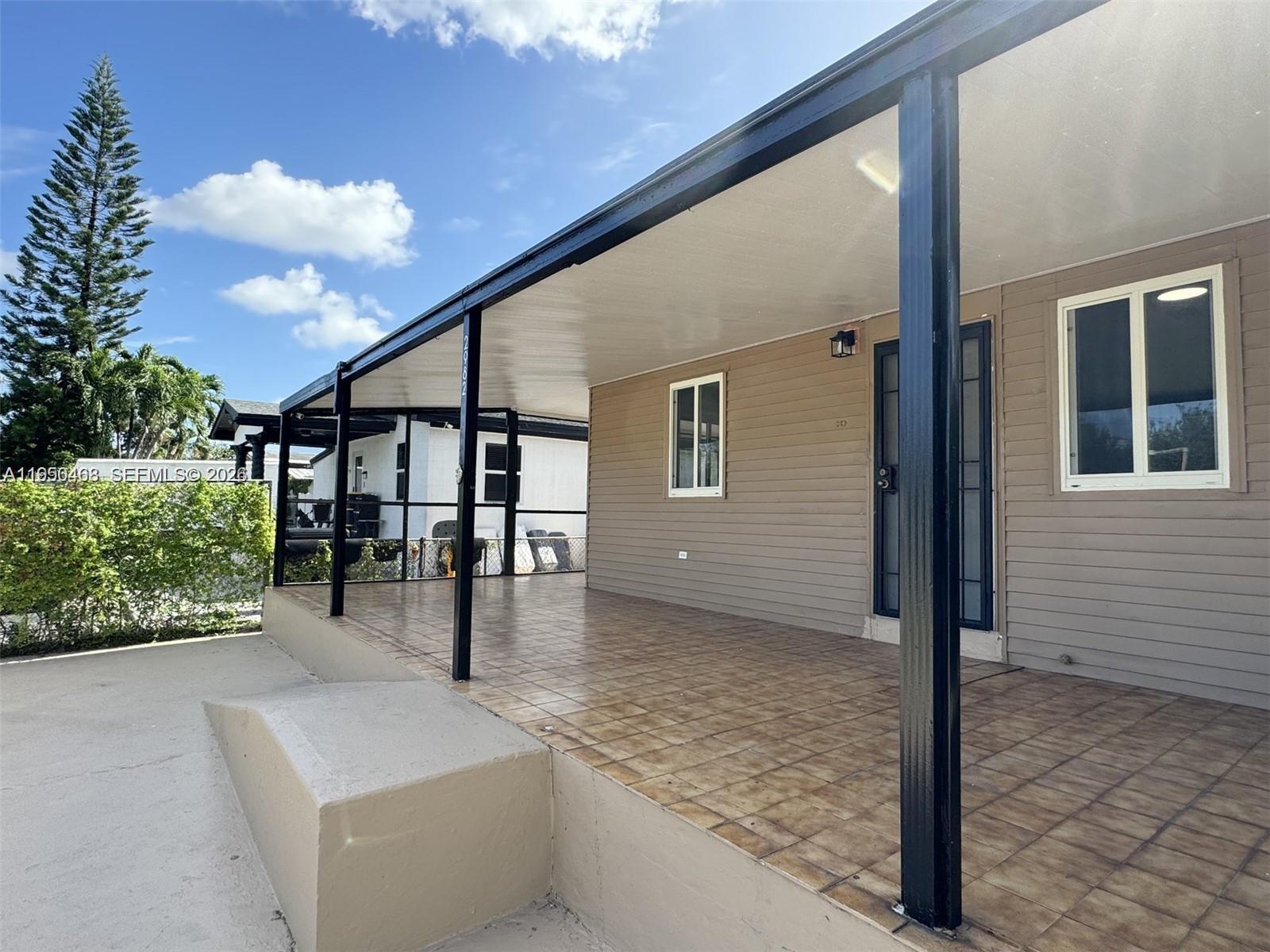 2982 Northwest 95th Street Miami, FL 33147 - Photo 4 of 30 a balcony with table and chairs