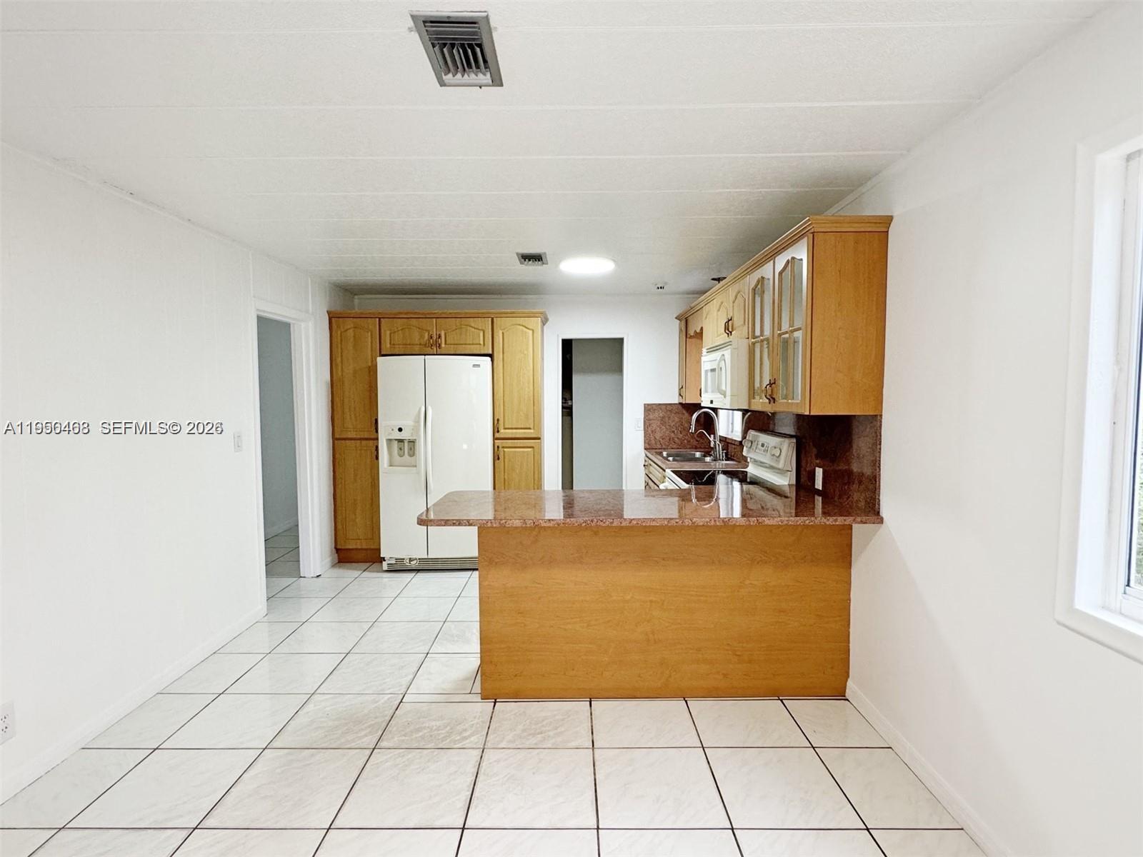 2982 Northwest 95th Street Miami, FL 33147 - Photo 6 of 30 a view of kitchen with furniture and large window