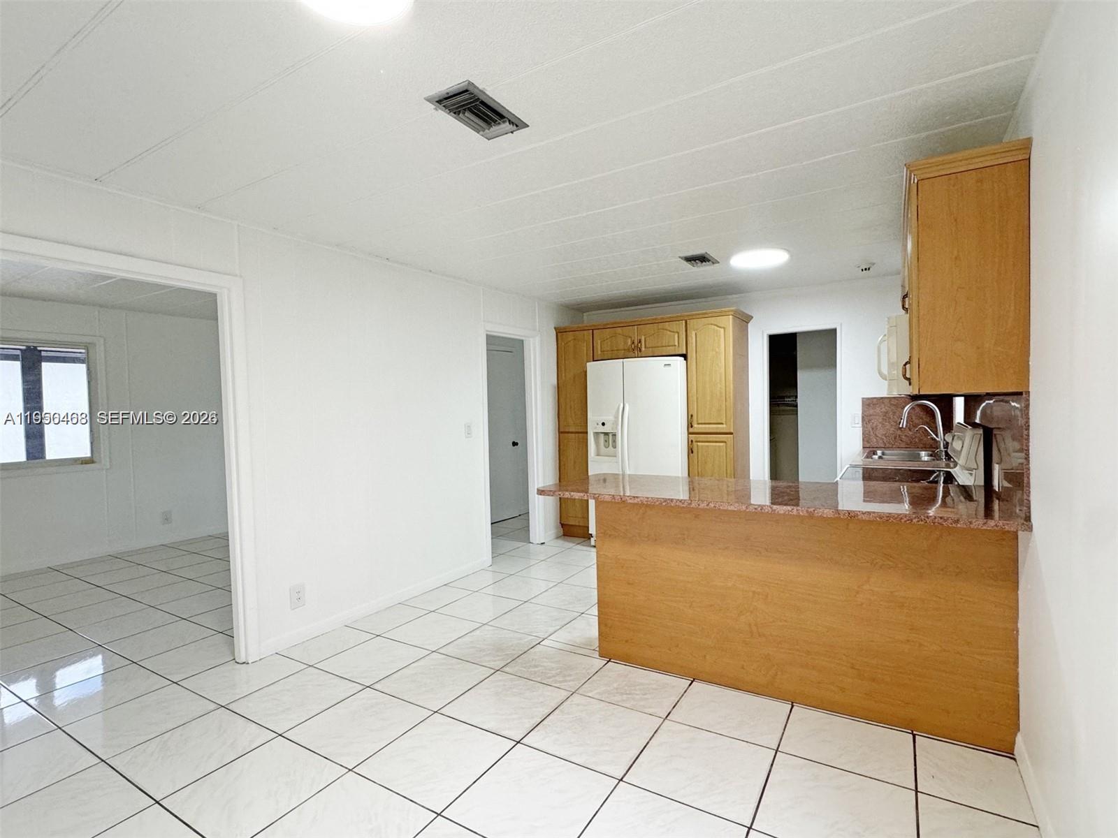 2982 Northwest 95th Street Miami, FL 33147 - Photo 8 of 30 a living room with furniture and a dining table