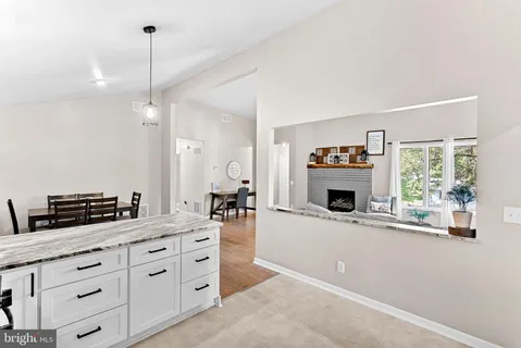 a kitchen with a sink and a fireplace