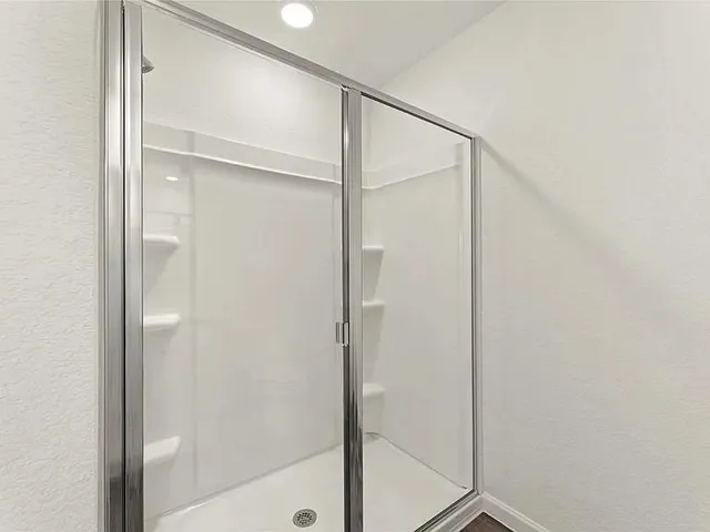 a bathroom with a glass shower door