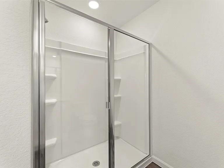 5909 Sahara Drive Forney, TX 75126 - Photo 19 of 21 a bathroom with a glass shower door