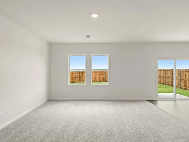an empty room with a empty space and windows