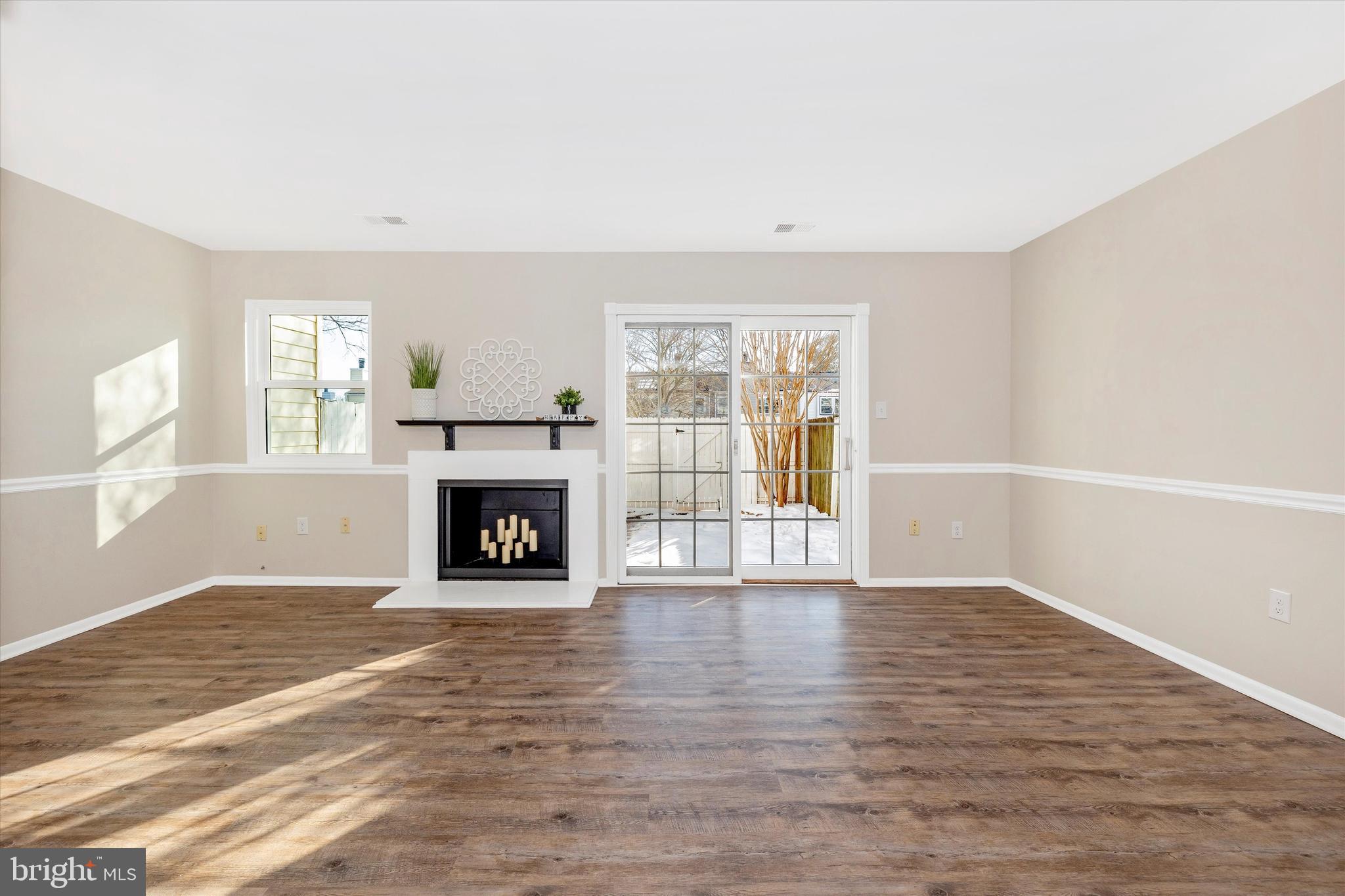 17513 Hoskinson Road Poolesville, MD 20837 - Photo 14 of 44 a view of an empty room with wooden floor fireplace and a window