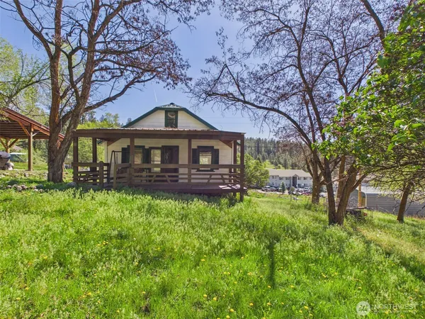 a front view of a house with yard and green space