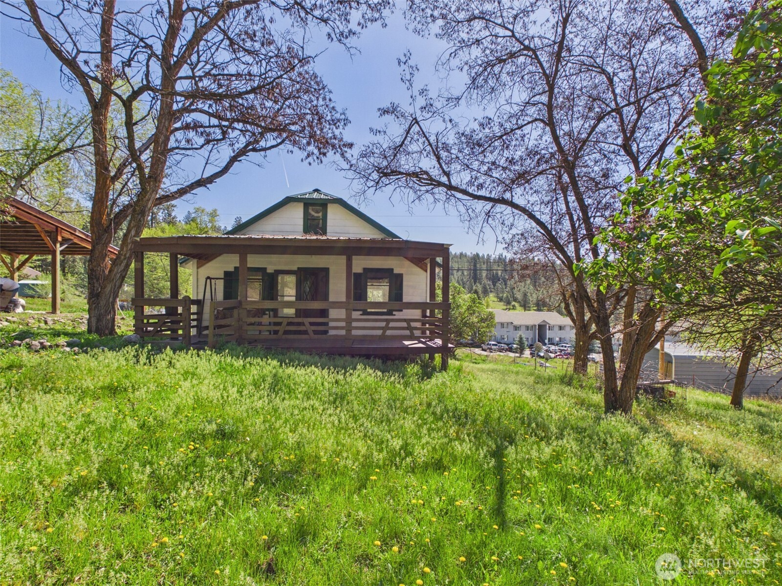 50 Klondike Road Republic, WA 99166 - Photo 1 of 18 a front view of a house with yard and green space