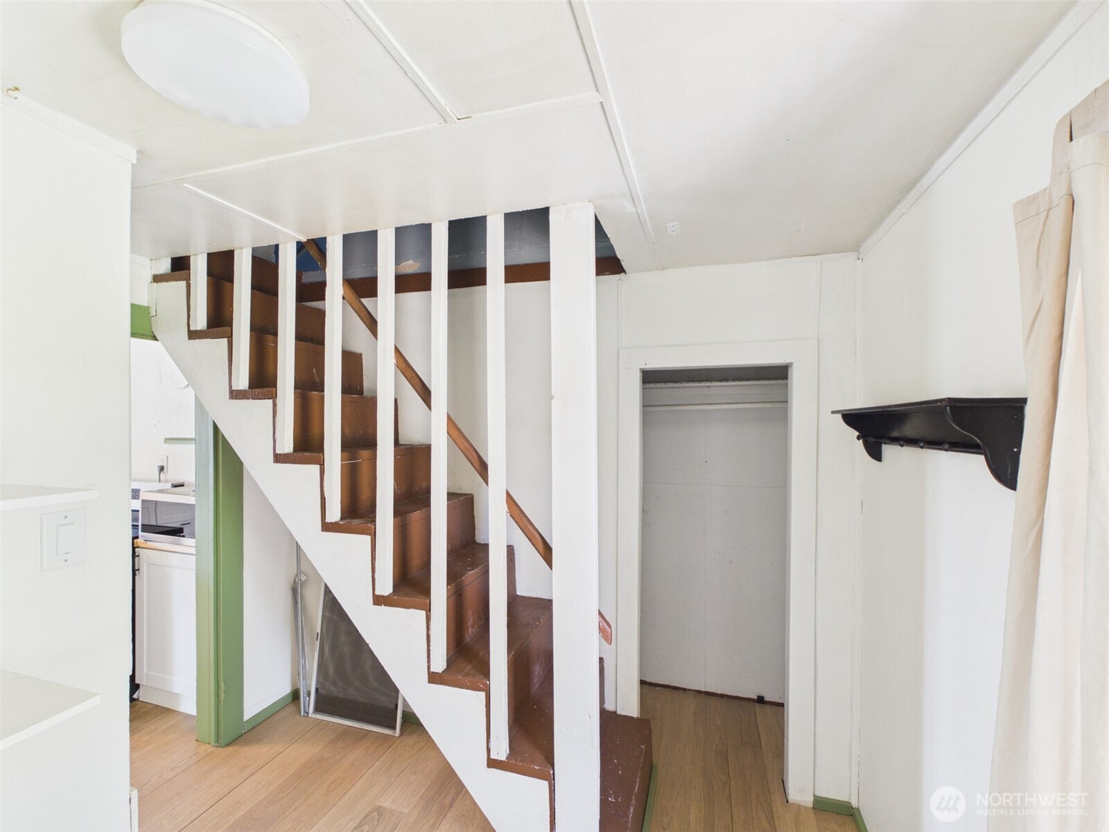 50 Klondike Road Republic, WA 99166 - Photo 10 of 18 a view of staircase with lots of frames on wall and wooden floor