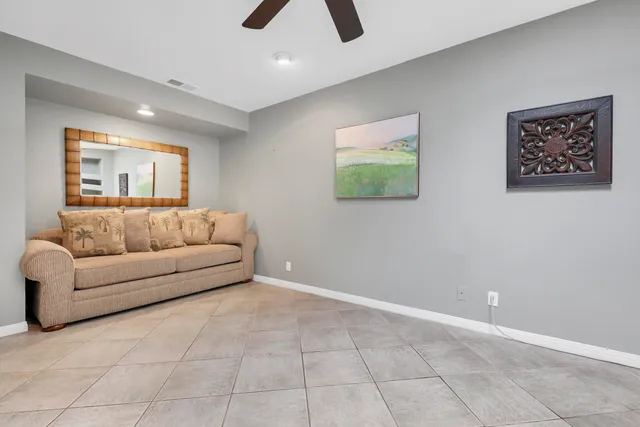 a bedroom with a bed and a lamp on dresser