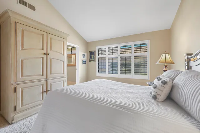 a bathroom with a double vanity sink mirror and next to a window