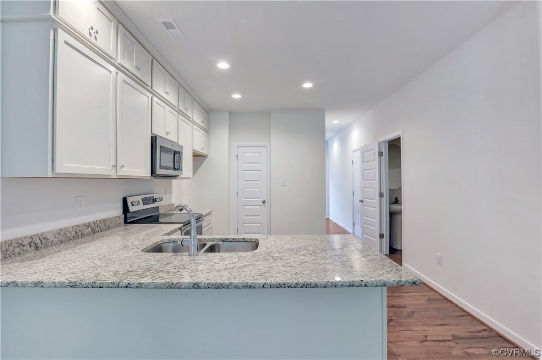 12867 Deep Wl Road Midlothian, VA 23112 - Photo 8 of 40 a kitchen with stainless steel appliances granite countertop a sink a stove and a refrigerator