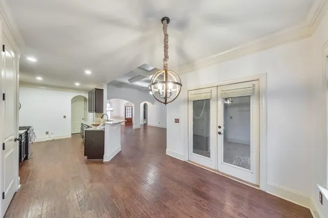 a kitchen with granite countertop stainless steel appliances a sink stove top oven and cabinets
