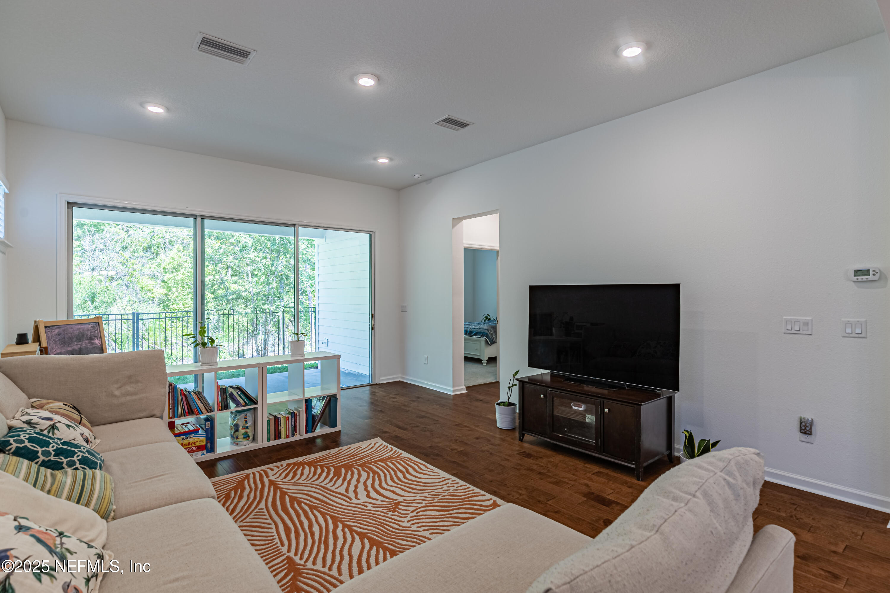383 Windswept Way Street St. Augustine, FL 32092 - Photo 17 of 34 a living room with furniture and a flat screen tv