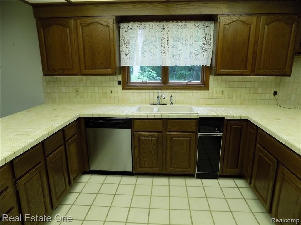 4650 Clyde Road Holly, MI 48442 - Photo 21 of 68 kitchen food prep areas showing dish washer on the left and the trash compactor on the right