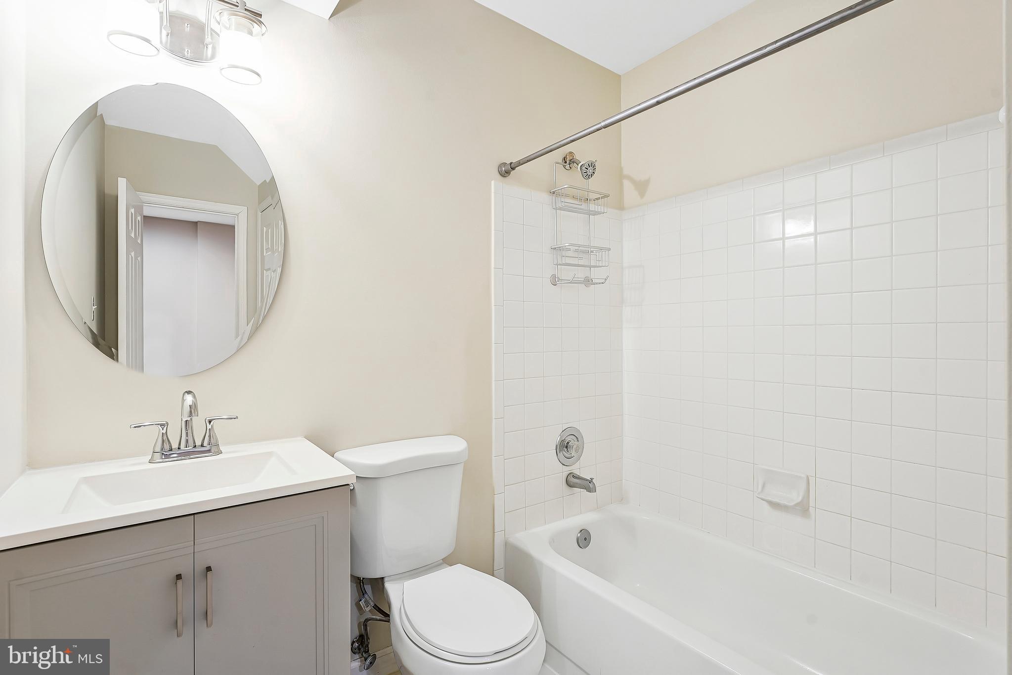 1469 Hampton Hill Circle McLean, VA 22101 - Photo 38 of 62 a bathroom with a bathtub shower sink vanity mirror and toilet